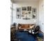 Cozy living room with gallery wall, hardwood floors, stylish furniture and a large sunny window at 67 Legare St # 305, Charleston, SC 29401