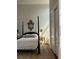 Serene bedroom with four-poster bed, gold mirror, and closet at 67 Legare St # 305, Charleston, SC 29401