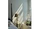 Bright bedroom featuring sunny window, bedside table with lamp and green plants at 67 Legare St # 305, Charleston, SC 29401
