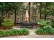 Beautiful patio with outdoor table and chairs surrounded by lush greenery at 67 Legare St # 305, Charleston, SC 29401