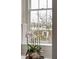 A well-lit window and flowers providing a view of trees at 67 Legare St # 305, Charleston, SC 29401
