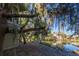 Picturesque backyard view featuring a tranquil pond surrounded by lush landscaping and neighboring properties at 796 Summerwind Cir, Edisto Beach, SC 29438