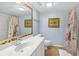 Bright bathroom featuring a vanity with a sink and shower with nautical-themed curtain at 796 Summerwind Cir, Edisto Beach, SC 29438