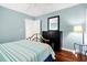 Well-lit bedroom featuring a bed, dresser, and hardwood floors at 796 Summerwind Cir, Edisto Beach, SC 29438