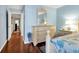Well-lit bedroom featuring a large closet, a dresser with a mirror, and hardwood floors at 796 Summerwind Cir, Edisto Beach, SC 29438