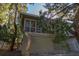 Beautiful home exterior featuring traditional siding, lattice, and mature trees, offering a picturesque and private setting at 796 Summerwind Cir, Edisto Beach, SC 29438