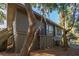Charming home exterior with traditional siding, lattice foundation, mature trees, and scenic surroundings at 796 Summerwind Cir, Edisto Beach, SC 29438