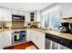Modern kitchen featuring stainless steel appliances, white cabinets, and granite countertops at 796 Summerwind Cir, Edisto Beach, SC 29438