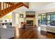 Open-concept living room with a fireplace, hardwood floors, and access to the screened-in porch at 796 Summerwind Cir, Edisto Beach, SC 29438
