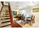 Inviting living room with a staircase, dining area, and comfortable seating at 796 Summerwind Cir, Edisto Beach, SC 29438