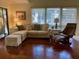 Bright living room with lots of natural light, comfortable seating, and wood floors at 796 Summerwind Cir, Edisto Beach, SC 29438