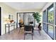 Relaxing screened porch featuring tile floors and a dining set overlooking the garden at 796 Summerwind Cir, Edisto Beach, SC 29438