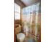 Cozy bathroom showcasing playful beach-themed shower curtain and matching decor for a cheerful ambiance at 8020 Nantuckett Ave, North Charleston, SC 29420
