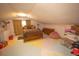 Attic bedroom with a sloped ceiling, a full-sized bed, wood furniture and colorful flooring at 8020 Nantuckett Ave, North Charleston, SC 29420
