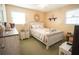 Cozy bedroom featuring a queen bed with decorative pillows, a white-washed wood frame, and a serene setting at 8020 Nantuckett Ave, North Charleston, SC 29420