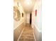 Bright hallway with wood-look tile, modern lighting, and framed art adding character to the neutral space at 8020 Nantuckett Ave, North Charleston, SC 29420
