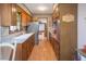 Well-lit kitchen with stainless steel appliances, wood cabinets, and a large sink beneath a window at 8020 Nantuckett Ave, North Charleston, SC 29420