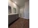 This bathroom includes a double sink vanity, a glass shower, and wood flooring at 911 Woodside Creek Ln, Summerville, SC 29486
