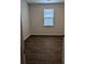 An empty bedroom featuring hardwood floors, white walls, and a window at 911 Woodside Creek Ln, Summerville, SC 29486