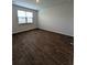 This bedroom has hardwood flooring, neutral paint colors, and a light-filled window at 911 Woodside Creek Ln, Summerville, SC 29486