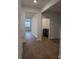 Open hallway with hardwood floors leading to the living area and laundry room at 911 Woodside Creek Ln, Summerville, SC 29486
