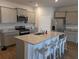 Stylish kitchen featuring granite countertops, stainless appliances, gray cabinets and a large island at 911 Woodside Creek Ln, Summerville, SC 29486