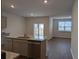 Open kitchen with granite countertops, gray cabinets, and stainless steel appliances at 911 Woodside Creek Ln, Summerville, SC 29486