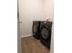 Laundry room featuring black Samsung washer and dryer set and hardwood floors at 911 Woodside Creek Ln, Summerville, SC 29486