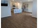 Open floor plan with a kitchen island and stainless appliances connecting to the living room at 911 Woodside Creek Ln, Summerville, SC 29486