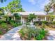 Charming single-story house with metal roof and well-manicured landscaping with a tiered fountain at 1025 Riverland Woods Pl # 608, Charleston, SC 29412