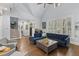 Inviting living room with blue sofa, hardwood floors, and large windows with shutters at 114 Colleton Ave, Summerville, SC 29483