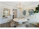 Bright dining area featuring pendant lighting, shiplap walls, and wood-look flooring at 116 Snow St, Summerville, SC 29486