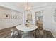 Open dining room showcasing modern art, pendant light, and adjacent kitchen view at 116 Snow St, Summerville, SC 29486