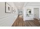 Bright hallway features wood floors, shiplap walls, and modern decor at 116 Snow St, Summerville, SC 29486