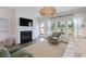 Bright living room boasts a cozy fireplace, modern furnishings, and plenty of natural light at 116 Snow St, Summerville, SC 29486