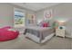 Bright bedroom with a large beanbag, playful wall art, and a window view at 1184 Reserve Ln, Awendaw, SC 29429