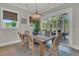 Dining room features a farmhouse table, chandelier, and sliding glass doors to the backyard at 1184 Reserve Ln, Awendaw, SC 29429