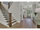 Inviting foyer features hardwood floors, staircase, and stylish decor, creating a warm and welcoming entrance to the home at 1184 Reserve Ln, Awendaw, SC 29429