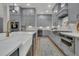 Spacious kitchen with stainless steel appliances, gray cabinets, and a breakfast bar at 1184 Reserve Ln, Awendaw, SC 29429