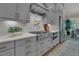 Kitchen boasts gray cabinets, stainless steel appliances, and quartz countertops at 1184 Reserve Ln, Awendaw, SC 29429