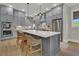 Bright kitchen features an oversized island, grey cabinets, and stainless steel appliances at 1184 Reserve Ln, Awendaw, SC 29429