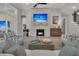 Bright living room features a fireplace, beach themed television, and comfortable seating at 1184 Reserve Ln, Awendaw, SC 29429