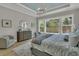 Serene main bedroom with large windows, stylish furnishings, and a comfortable seating area for relaxation and tranquility at 1184 Reserve Ln, Awendaw, SC 29429
