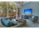 Outdoor living space boasts wicker furniture, a television, and a beautiful view of the backyard at 1184 Reserve Ln, Awendaw, SC 29429