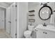 Cozy bathroom featuring a toilet, vanity with sink, and decorative shelving at 1203 Meadow Park Ln # B, Mount Pleasant, SC 29464