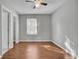 Bedroom with a large window letting in natural light, wood-look floors and grey paint at 1203 Meadow Park Ln # B, Mount Pleasant, SC 29464