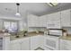 Well-lit kitchen with white appliances, functional layout, and lots of cabinet space at 1203 Meadow Park Ln # B, Mount Pleasant, SC 29464