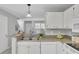 Bright kitchen featuring stainless steel sink and white cabinets at 1203 Meadow Park Ln # B, Mount Pleasant, SC 29464