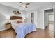 Bedroom with a ceiling fan, hardwood floors, and view into bathroom at 1203 Meadow Park Ln # B, Mount Pleasant, SC 29464