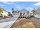 Inviting single-story home with a charming front porch and a two-car garage on a sunny day at 139 Calm Water Way, Summerville, SC 29486